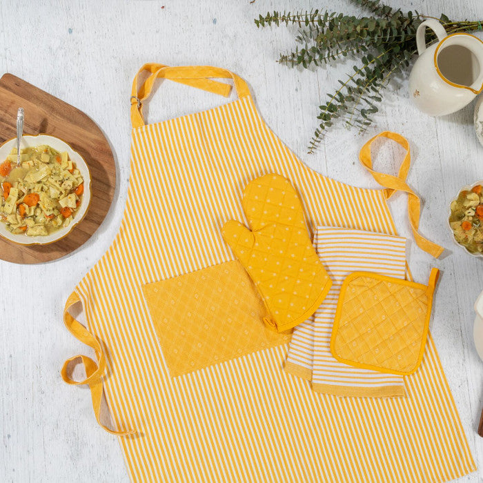 Overhead view of a yellow striped apron with matching oven mitts and pot holders, surrounded by bowls of soup and kitchen items.