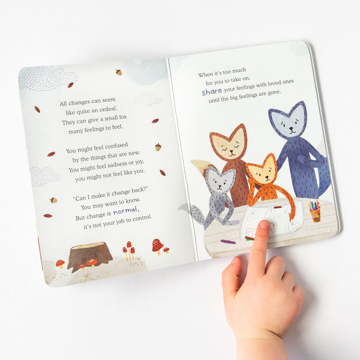 Childâs hand pointing to an open childrenâs book with illustrated animal characters and comforting text about emotions and support.