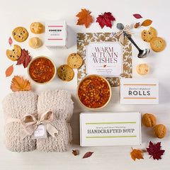 Overhead image displaying "Warm Autumn Wishes" card, Spoonful of Comfort Box, styled with soups, rolls and cookies.