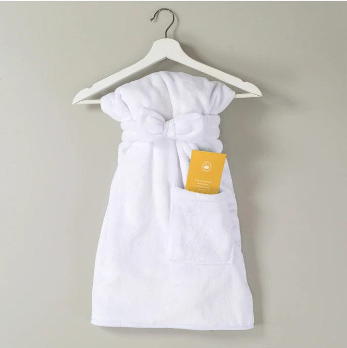 White robe tied at the waist, hanging on a hanger with a yellow tag attached.